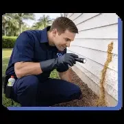 Technician working outside a Texas home during pest control service.