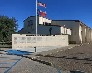 Veterans Memorial Mall in East Bernard with American flags, representing veteran‑owned service values.
